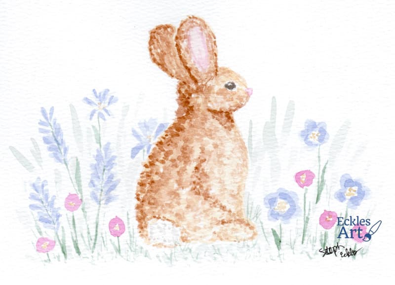 A watercolor painting of a brown rabbit sitting among pastel-colored wildflowers and greenery. The rabbit is in side profile and has soft fur with delicate shading, large upright ears, and a gentle expression. The background features light periwinkle and pink flowers with green leaves.