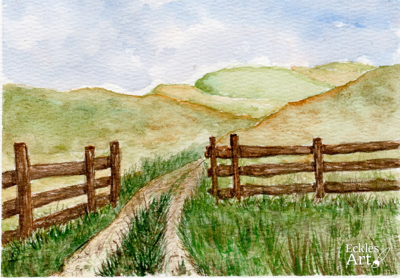 A peaceful rural scene featuring a pasture, a road, and a fence stretching through the landscape. The dirt road bisected by grassy growth gently curves through the open gate, inviting the viewer into the scene. A wooden fence composed of panesl with three parallel boards runs alongside. The pasture is filled with lush green grass, with rolling hills adding depth to the composition. The sky is a gentle blue in the top fourth with the sense of whispy cloud cover. The overall mood is calm and pastoral, evoking a sense of quiet country charm.