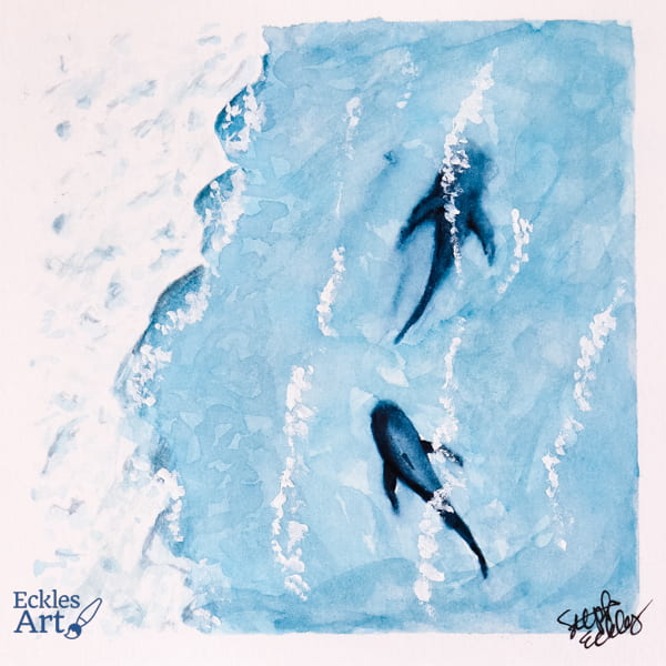 Overhead view of two dark shark shapes gliding along next to the surf near the shore.